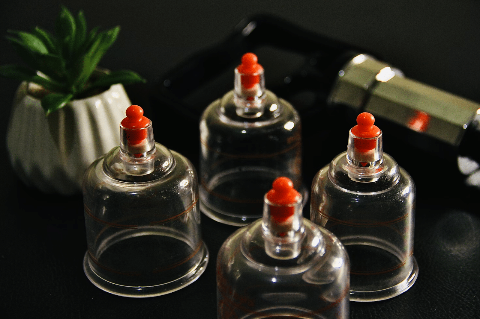 glass cups that are used for cupping therapy on a table